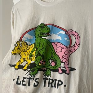Sturniolo Triplets merch, “LET’S TRIP”. Off white t-shirt with dinosaur design.